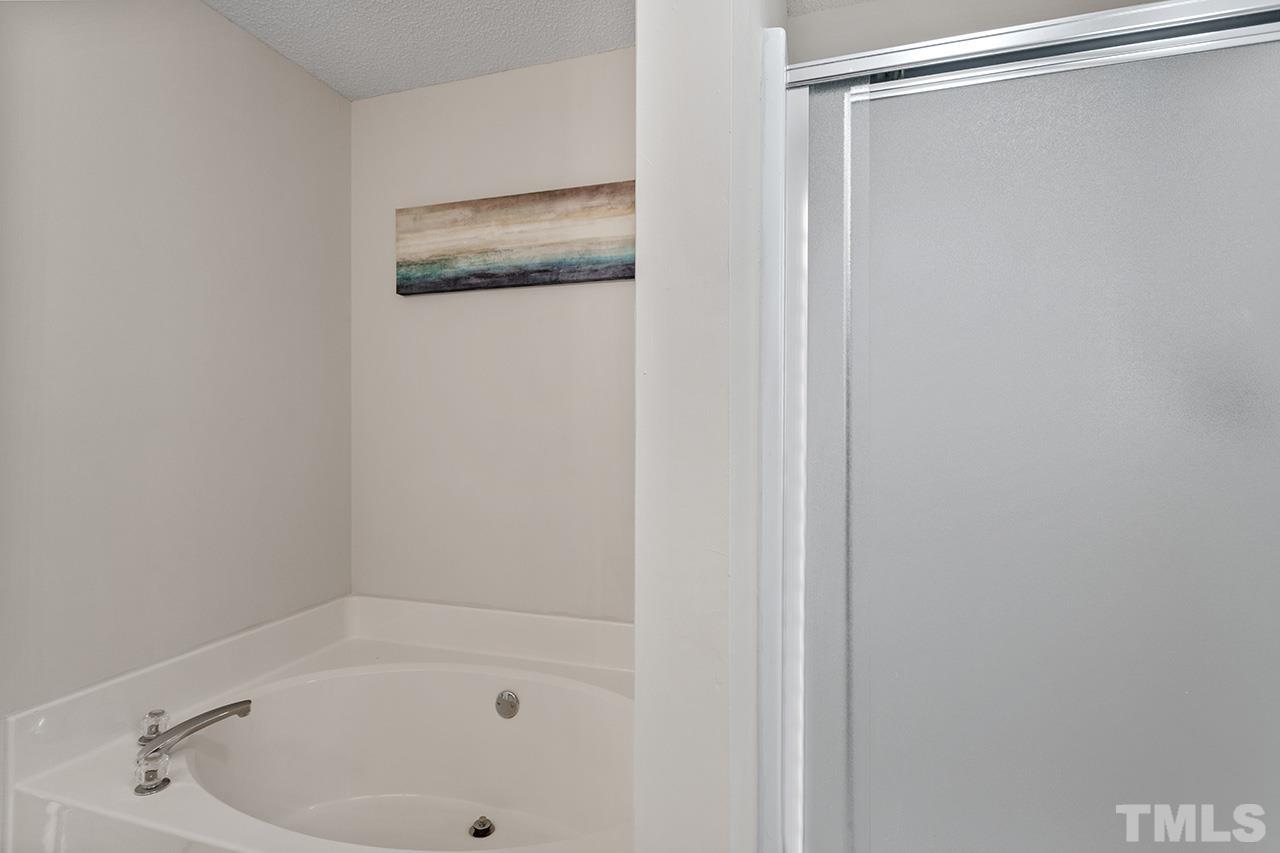 5504 Botany Bay Drive Raleigh, NC 27616 - Photo 17 of 23 a bathroom with a shower and a bath tub