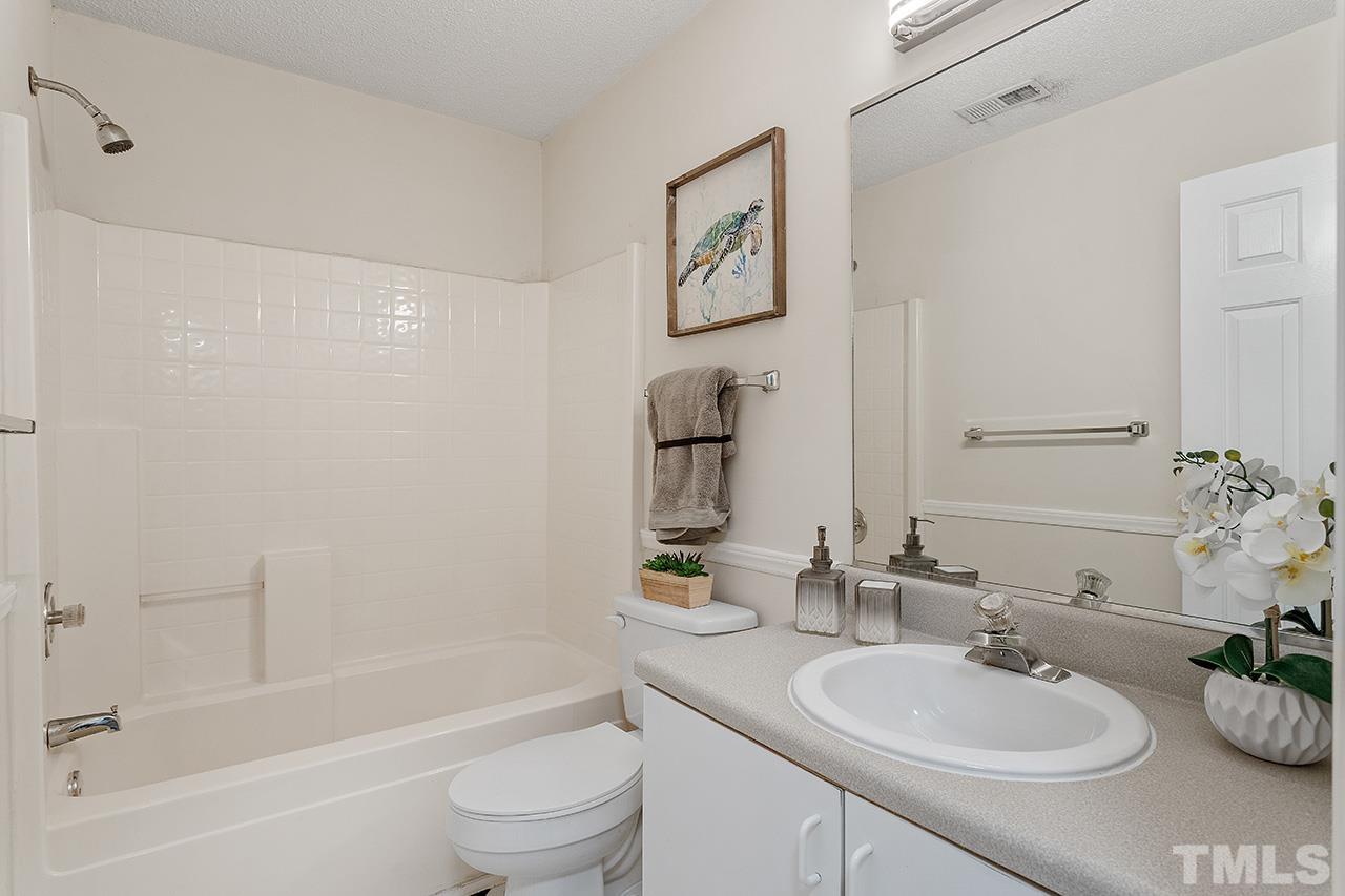 5504 Botany Bay Drive Raleigh, NC 27616 - Photo 20 of 23 a bathroom with a sink a toilet and shower