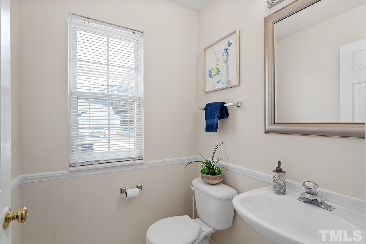 5504 Botany Bay Drive Raleigh, NC 27616 - Photo 6 of 23 a bathroom with a toilet sink and mirror
