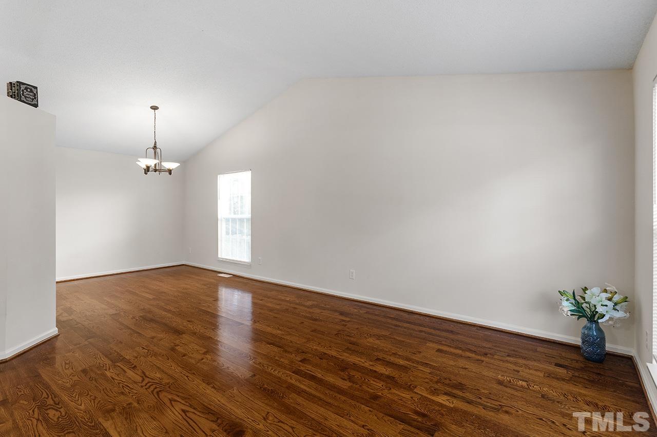 5504 Botany Bay Drive Raleigh, NC 27616 - Photo 7 of 23 an empty room with wooden floor and windows