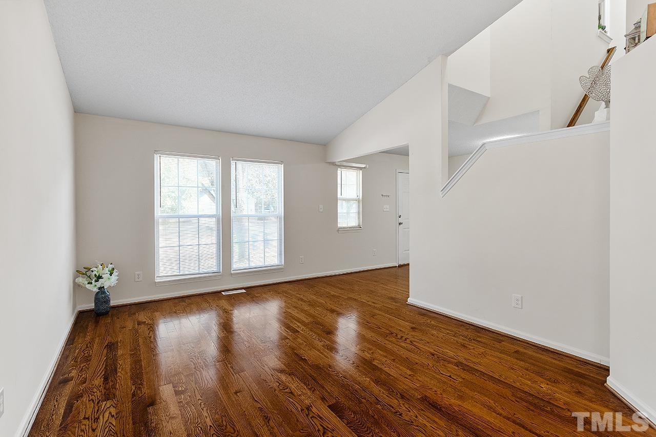 5504 Botany Bay Drive Raleigh, NC 27616 - Photo 8 of 23 a view of an empty room with wooden floor and a window
