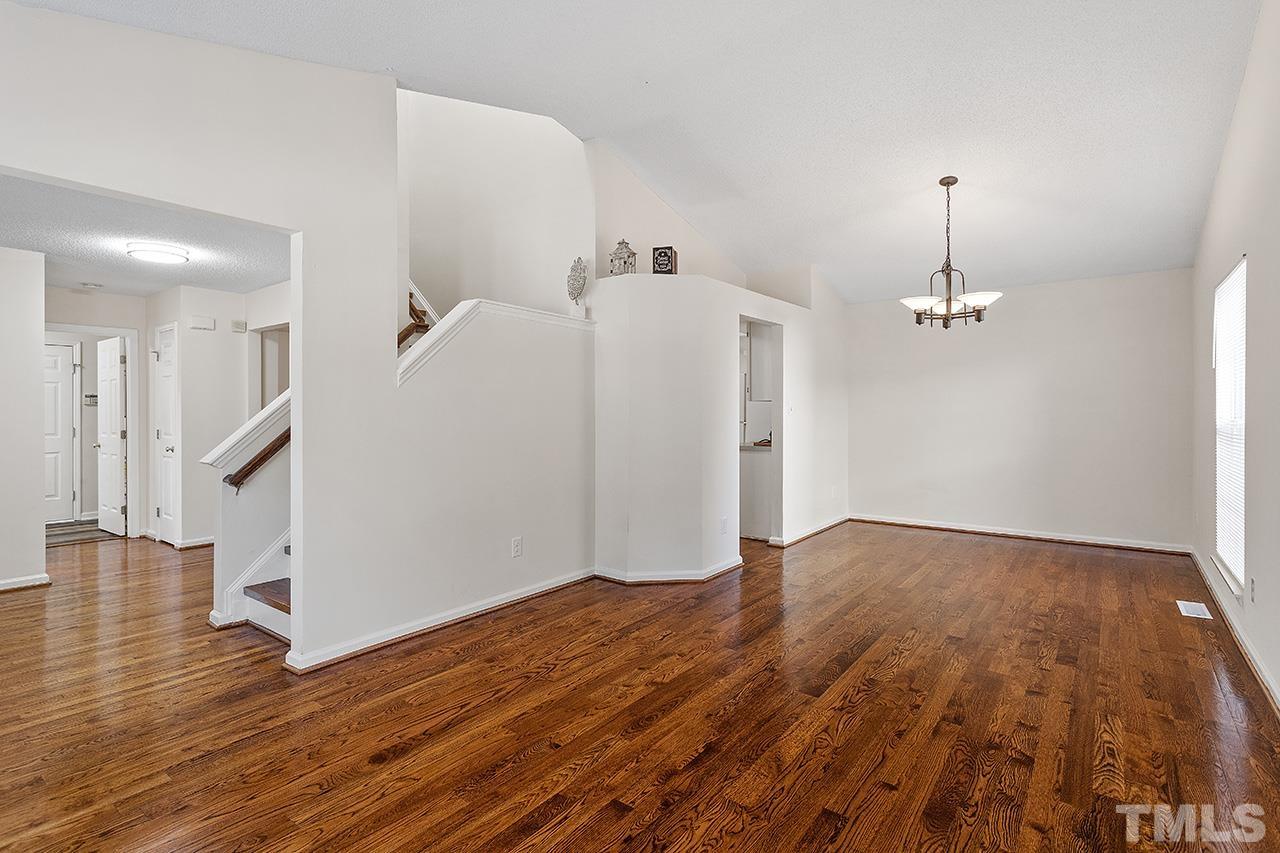 5504 Botany Bay Drive Raleigh, NC 27616 - Photo 9 of 23 an empty room with wooden floor and ceiling fan