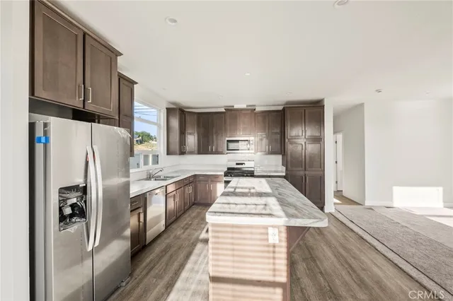 a kitchen with a stove sink and refrigerator
