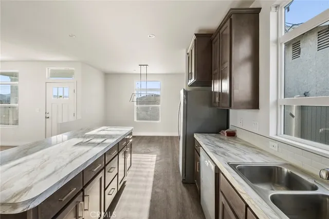 a kitchen with granite countertop a stove and a refrigerator