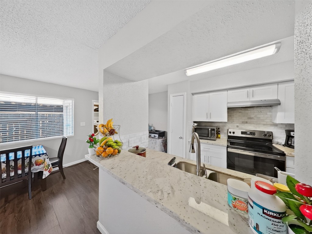 8101 Amelia Road, Unit 404 Houston, TX 77055 - Photo 13 of 39 a kitchen that has a lot of cabinets a sink and appliances in it