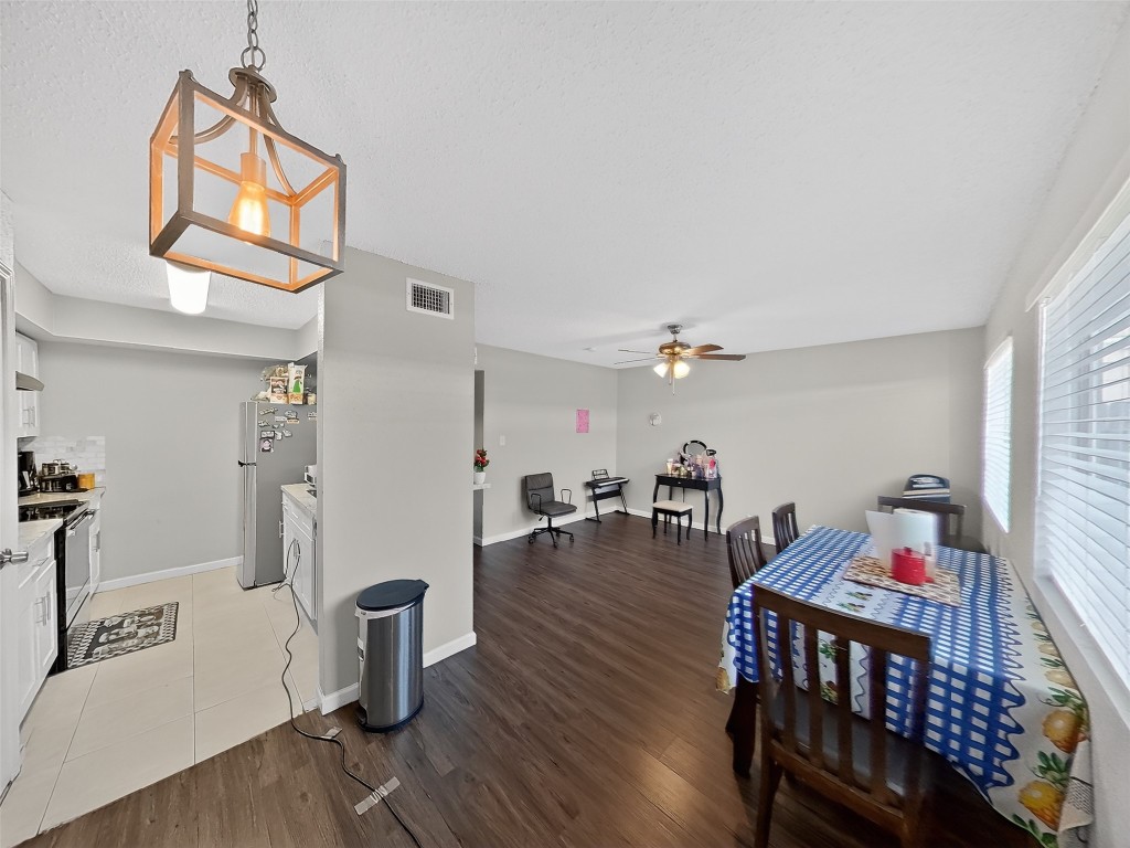 8101 Amelia Road, Unit 404 Houston, TX 77055 - Photo 18 of 39 a view of a dining room with furniture and wooden floor
