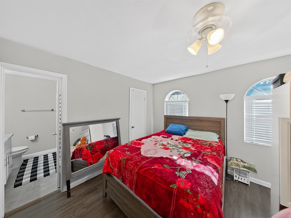 8101 Amelia Road, Unit 404 Houston, TX 77055 - Photo 36 of 39 a bedroom with a bed and wooden floor