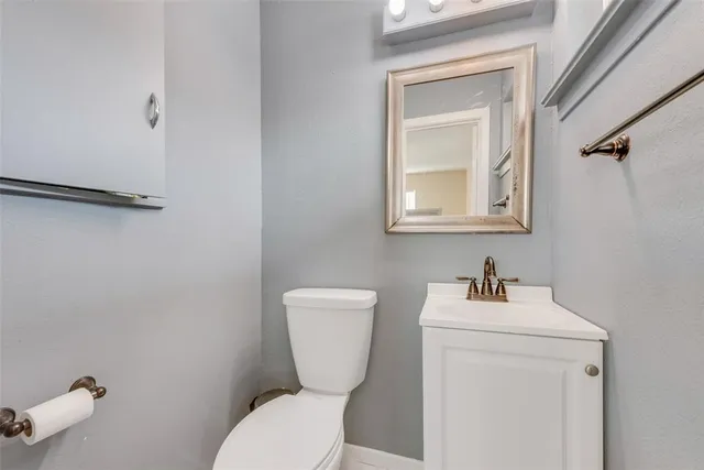 a bathroom with a toilet a sink and mirror