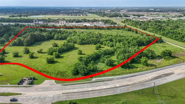 a view of a yard with plants and lake view