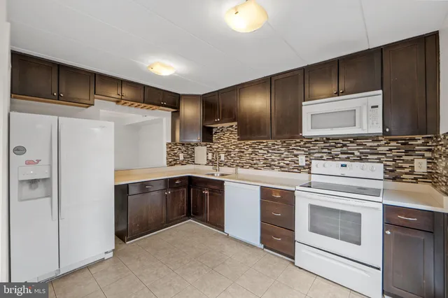 a kitchen with stainless steel appliances granite countertop a stove and a refrigerator