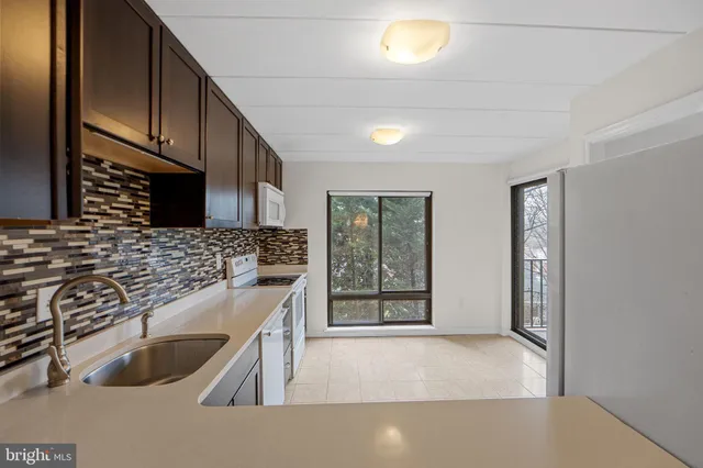 a kitchen with a sink cabinets and window