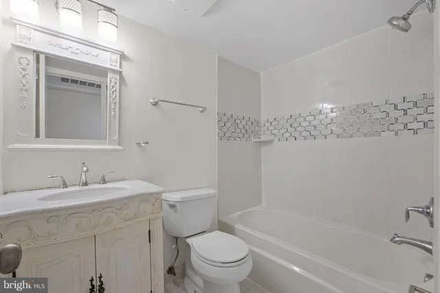 a bathroom with a sink a toilet and a bathtub