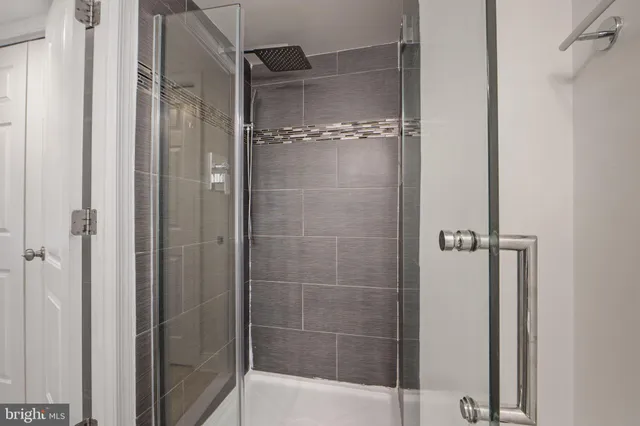 a bathroom with a glass shower door