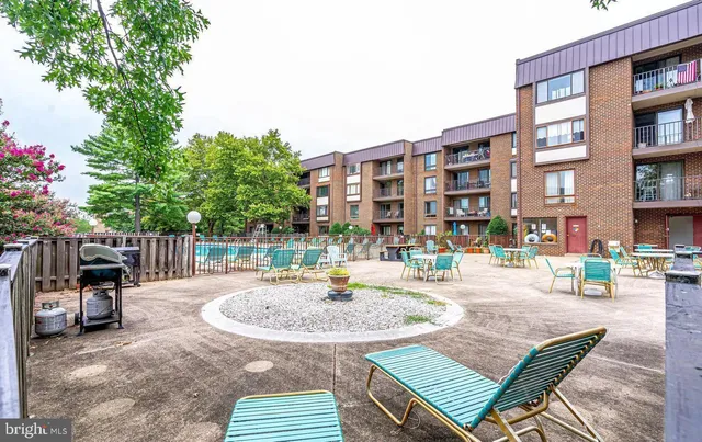 a view of a patio with a table and chairs