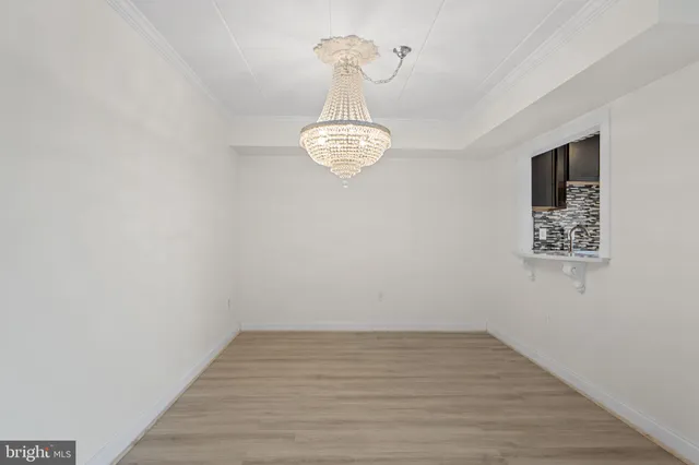 a view of a room with wooden floor and window