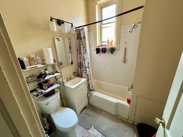 a white toilet sitting next to a bath tub shower