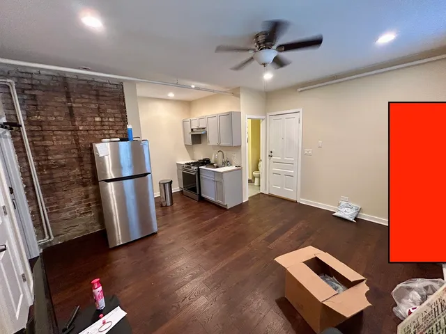 a kitchen with a refrigerator sink and cabinets