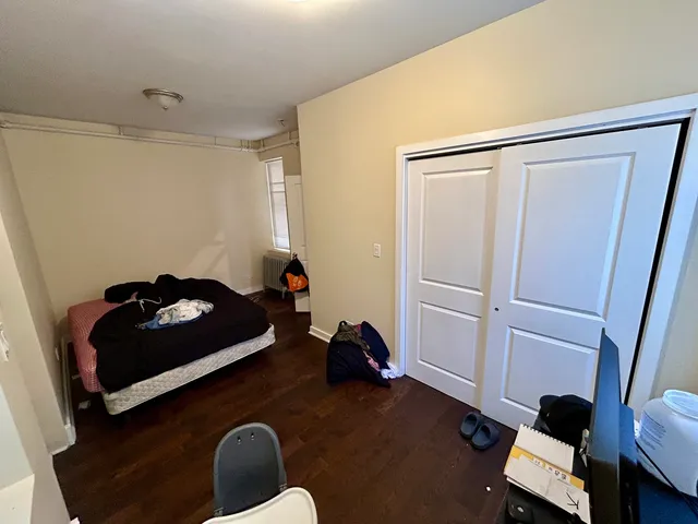 a cat sitting on a bed in a room