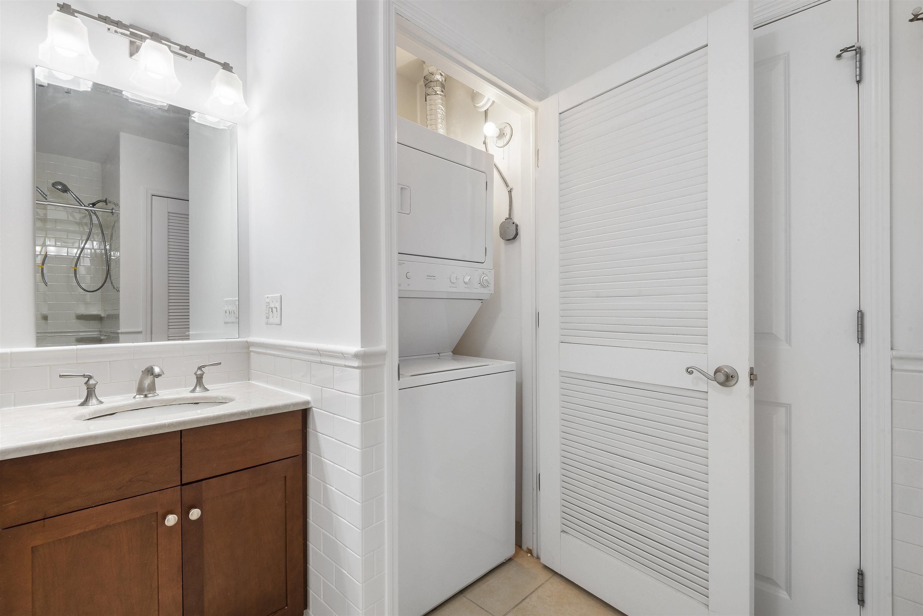 203-207 Hackensack Plank Road, Unit 5B Weehawken, NJ 07086 - Photo 11 of 18 a bathroom with a sink and a mirror