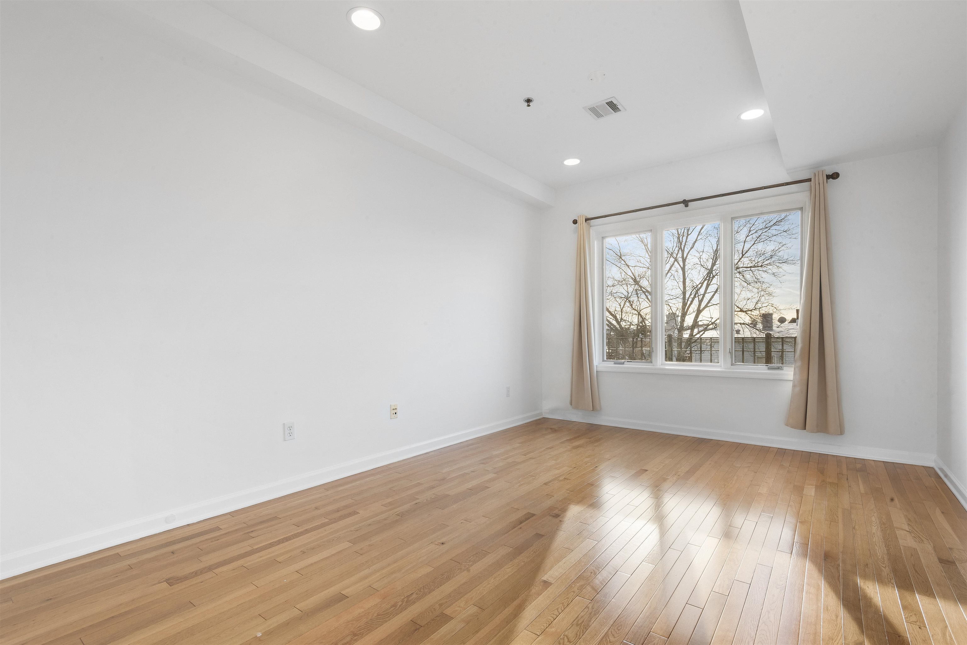 203-207 Hackensack Plank Road, Unit 5B Weehawken, NJ 07086 - Photo 16 of 18 wooden floor in an empty room with a window