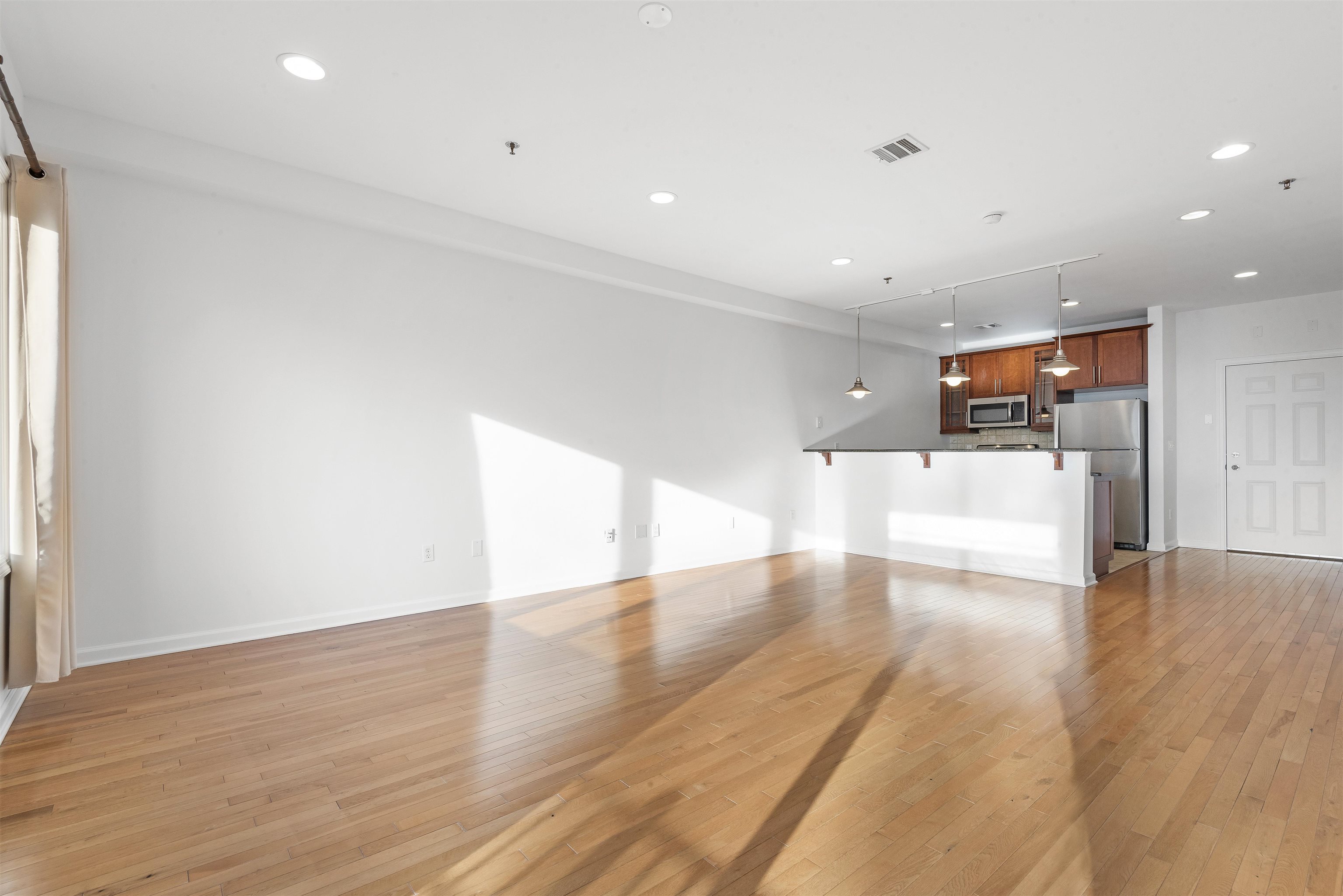 203-207 Hackensack Plank Road, Unit 5B Weehawken, NJ 07086 - Photo 6 of 18 a view of empty room with wooden floor