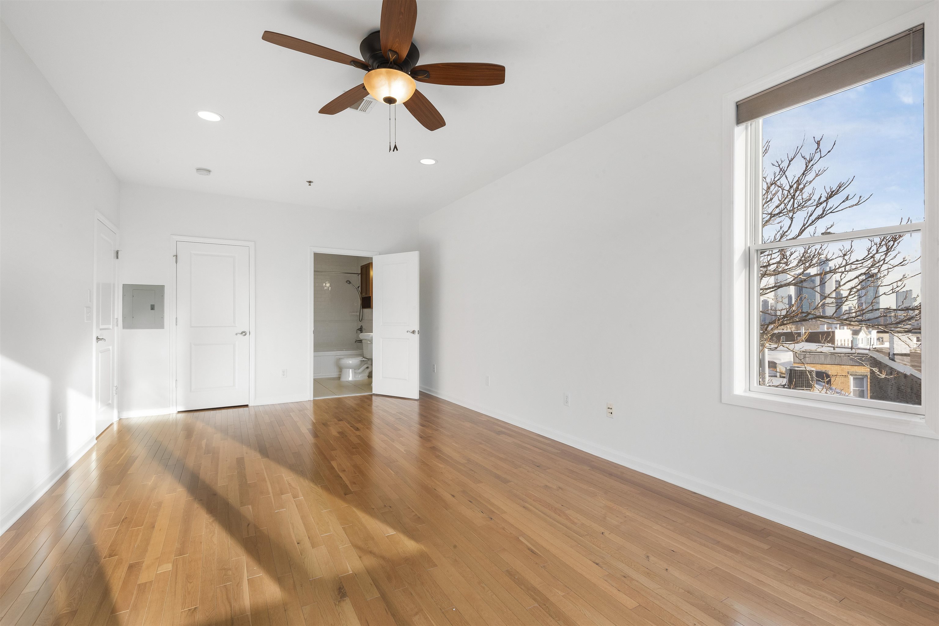 203-207 Hackensack Plank Road, Unit 5B Weehawken, NJ 07086 - Photo 8 of 18 a view of empty room with wooden floor and fan