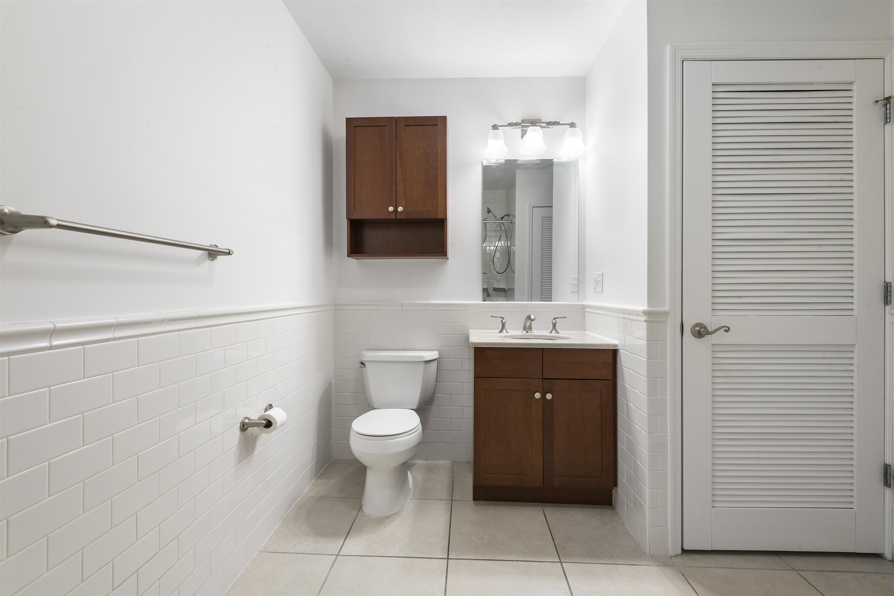 203-207 Hackensack Plank Road, Unit 5B Weehawken, NJ 07086 - Photo 10 of 18 a bathroom with a toilet sink and mirror