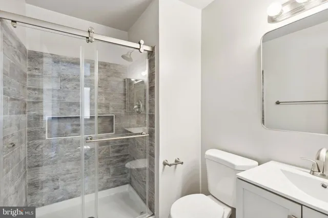 a bathroom with a shower and toilet