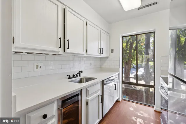 a kitchen with a sink and cabinets