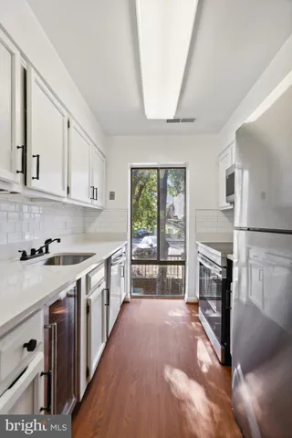 a kitchen with stainless steel appliances granite countertop a stove and a refrigerator