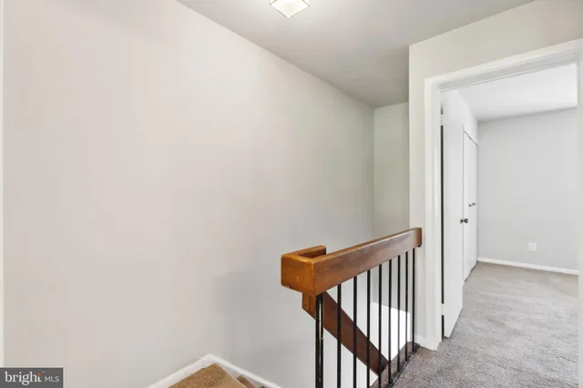 a view of a hallway with wooden floor and entryway