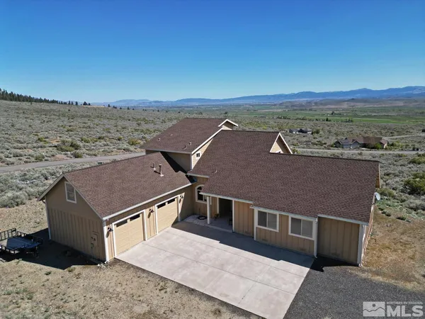an aerial view of a house with a yard