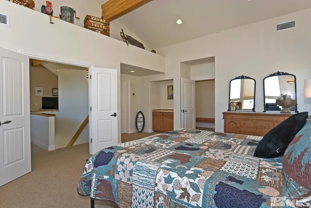 a bedroom with a bed and a tv