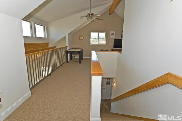 a view of a house with a large window and wooden fence
