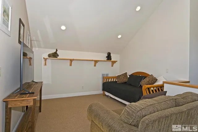 front view of a house with a large window and potted plants