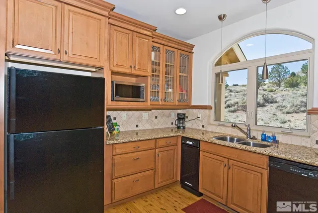 a dining room with furniture window and wooden floor