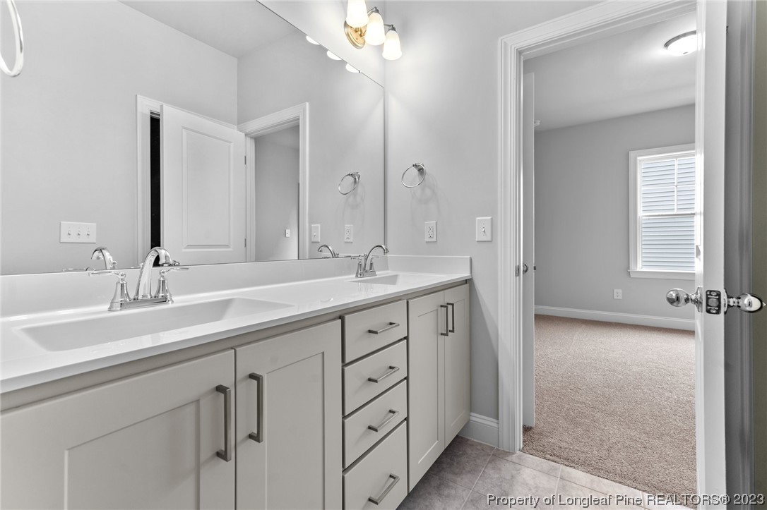 144 Kensington Dr Spring Lake Spring Lake, NC 28390 - Photo 12 of 22 a spacious bathroom with double sink and a mirror