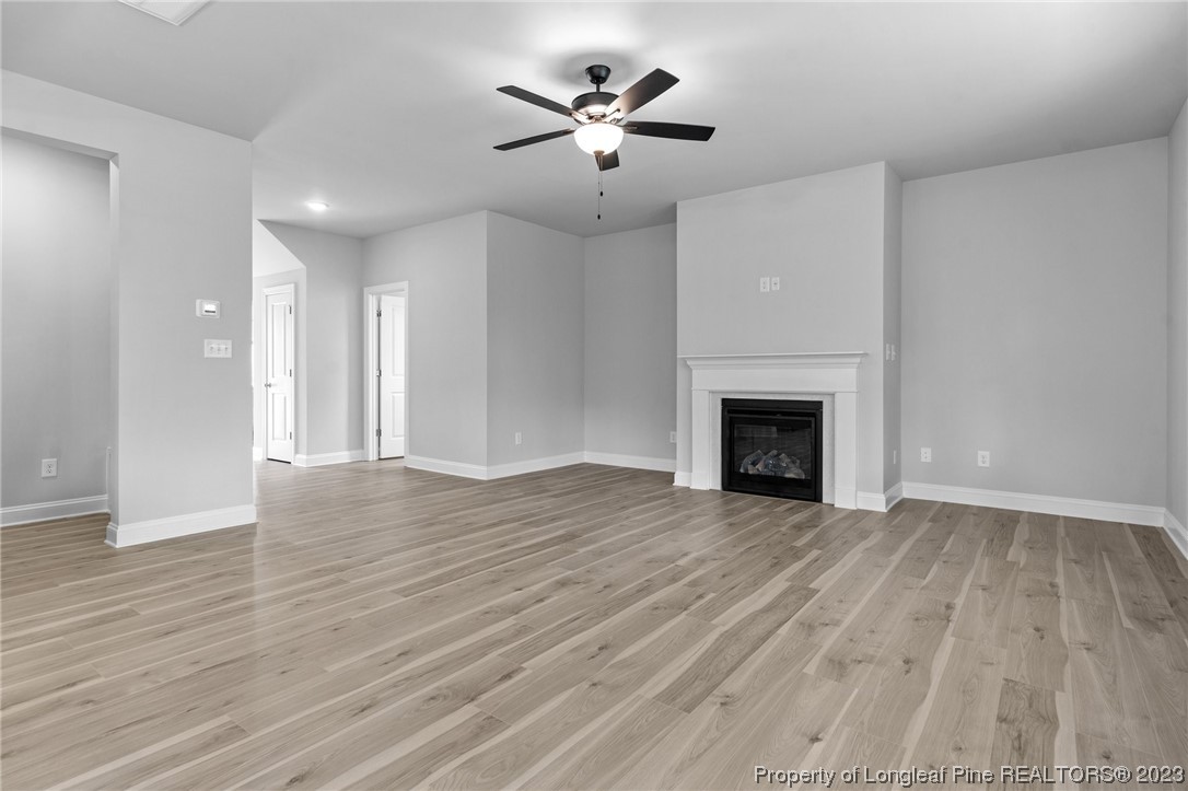 144 Kensington Dr Spring Lake Spring Lake, NC 28390 - Photo 4 of 22 a view of an empty room with wooden floor and a fireplace