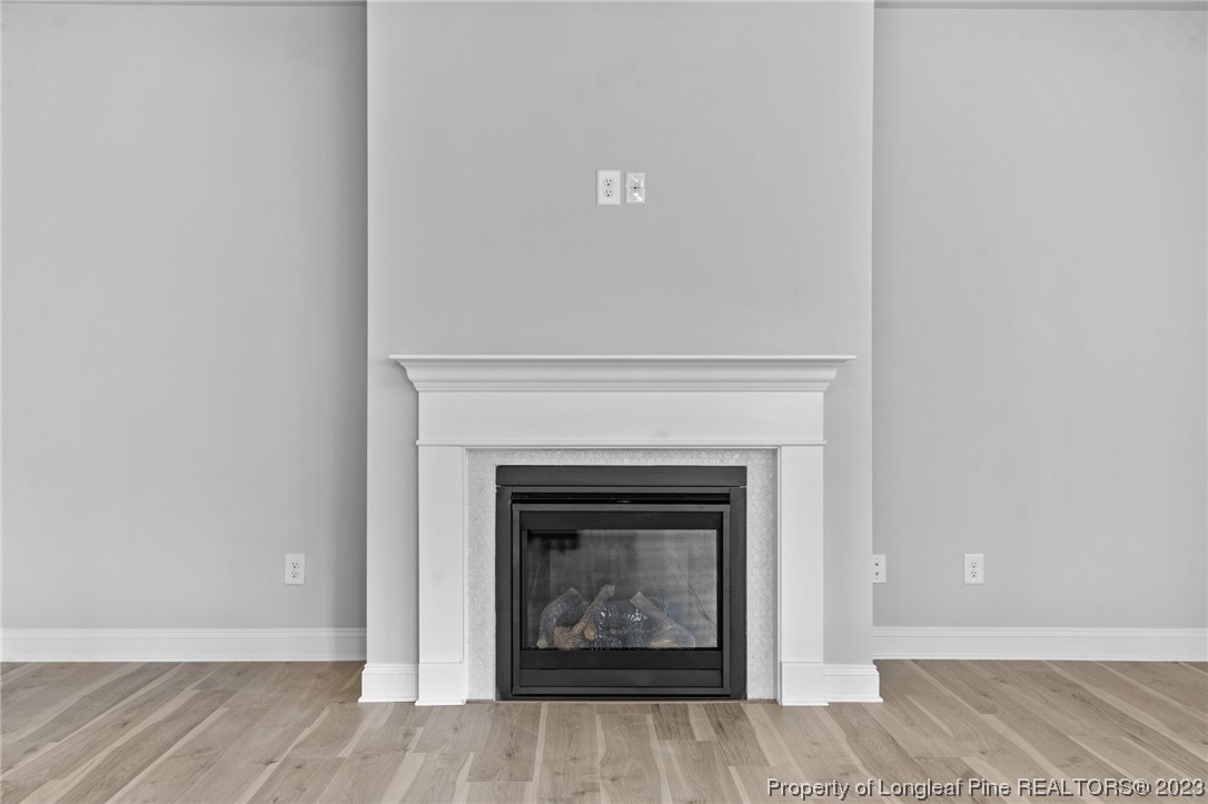 144 Kensington Dr Spring Lake Spring Lake, NC 28390 - Photo 5 of 22 a view of an empty room with wooden floor and a fireplace