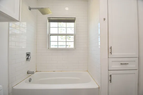 a white bath tub sitting next to a window