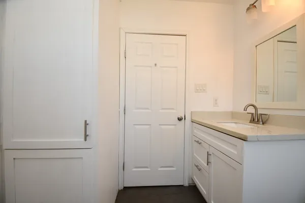 a bathroom with a sink a toilet and vanity
