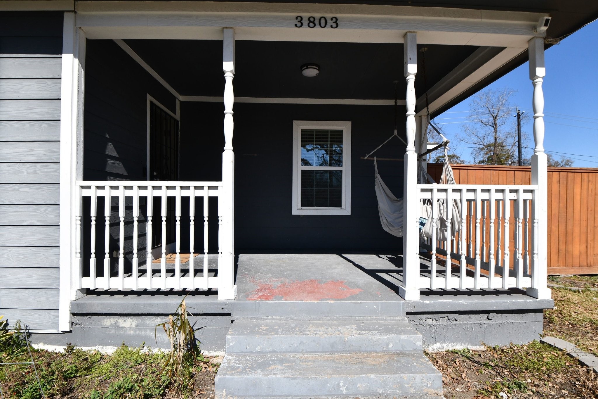 3803 Arbor Street Houston, TX 77004 - Photo 2 of 15 Charming front porch with classic white railings, a cozy hammock, and a welcoming entrance, perfect for relaxation and enjoying the outdoors.
