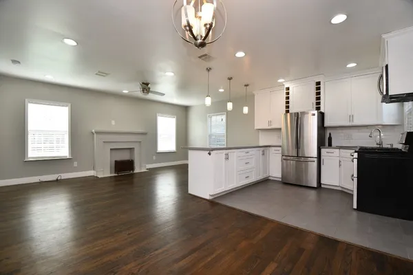 a view of kitchen with sink and refrigerator