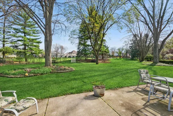 a view of a backyard with sitting area