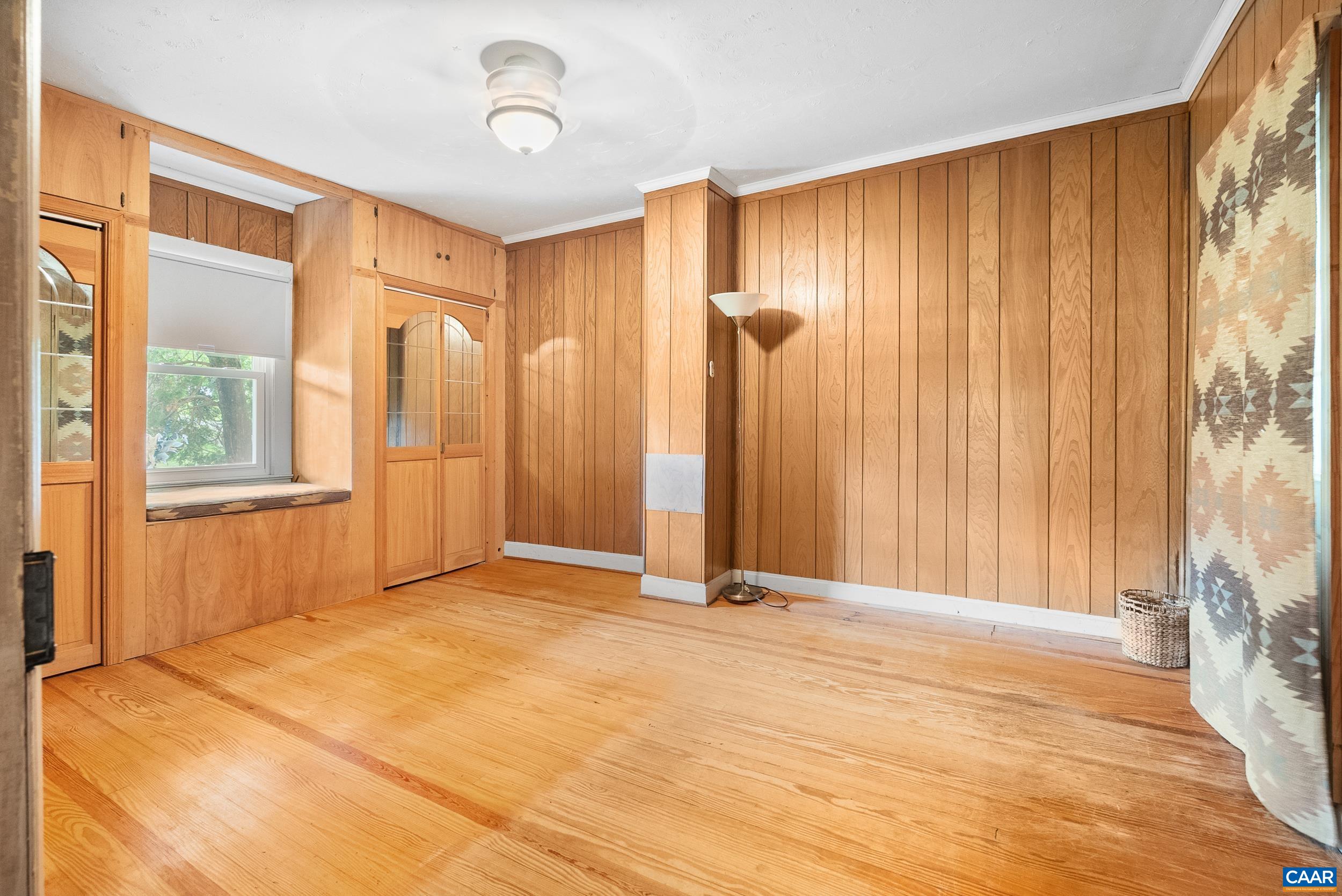 687 Gidsville Road Amherst, VA 24521 - Photo 13 of 70 a view of an empty room with wooden floor and a window