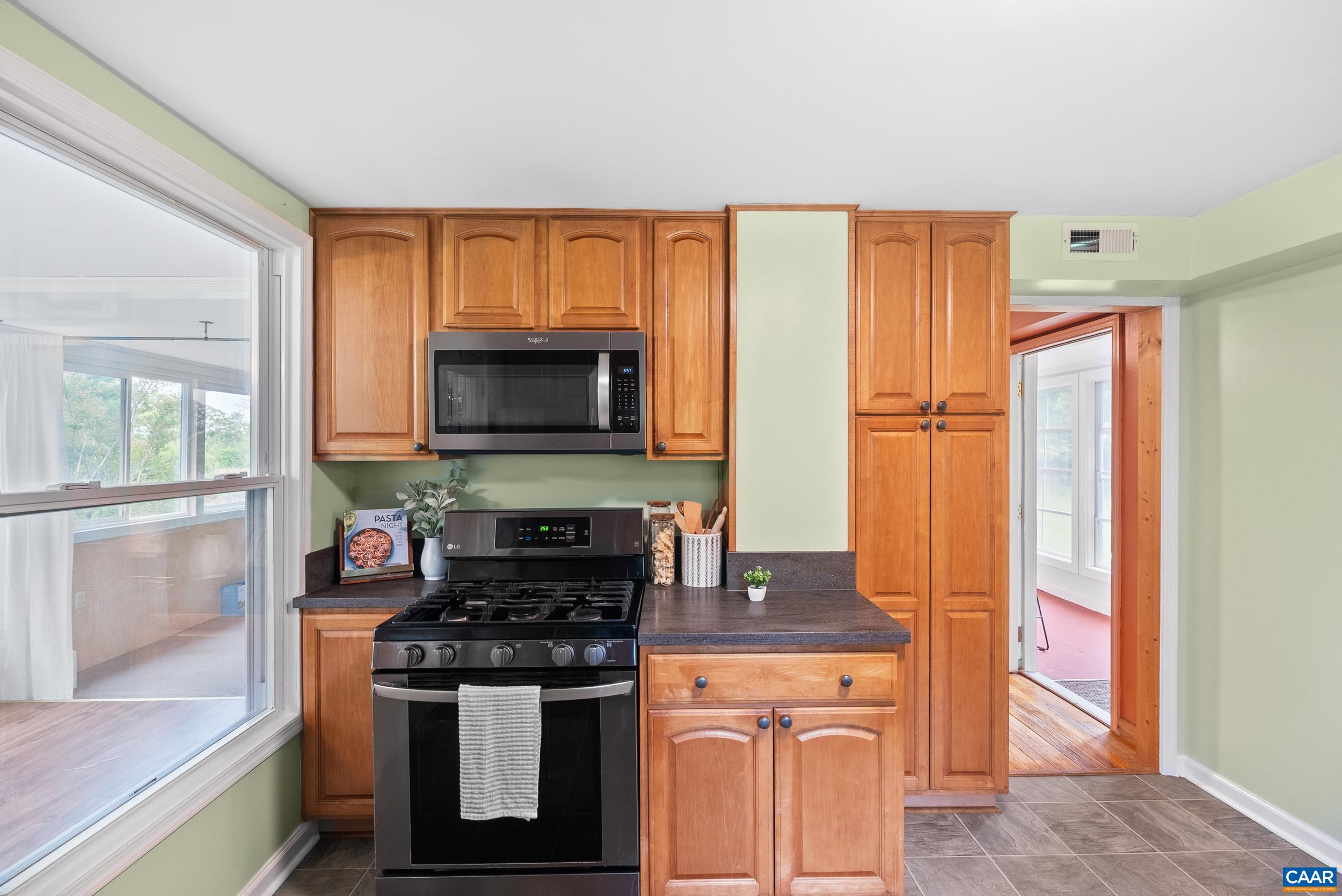 687 Gidsville Road Amherst, VA 24521 - Photo 22 of 70 a kitchen with stainless steel appliances granite countertop a stove a sink and a microwave