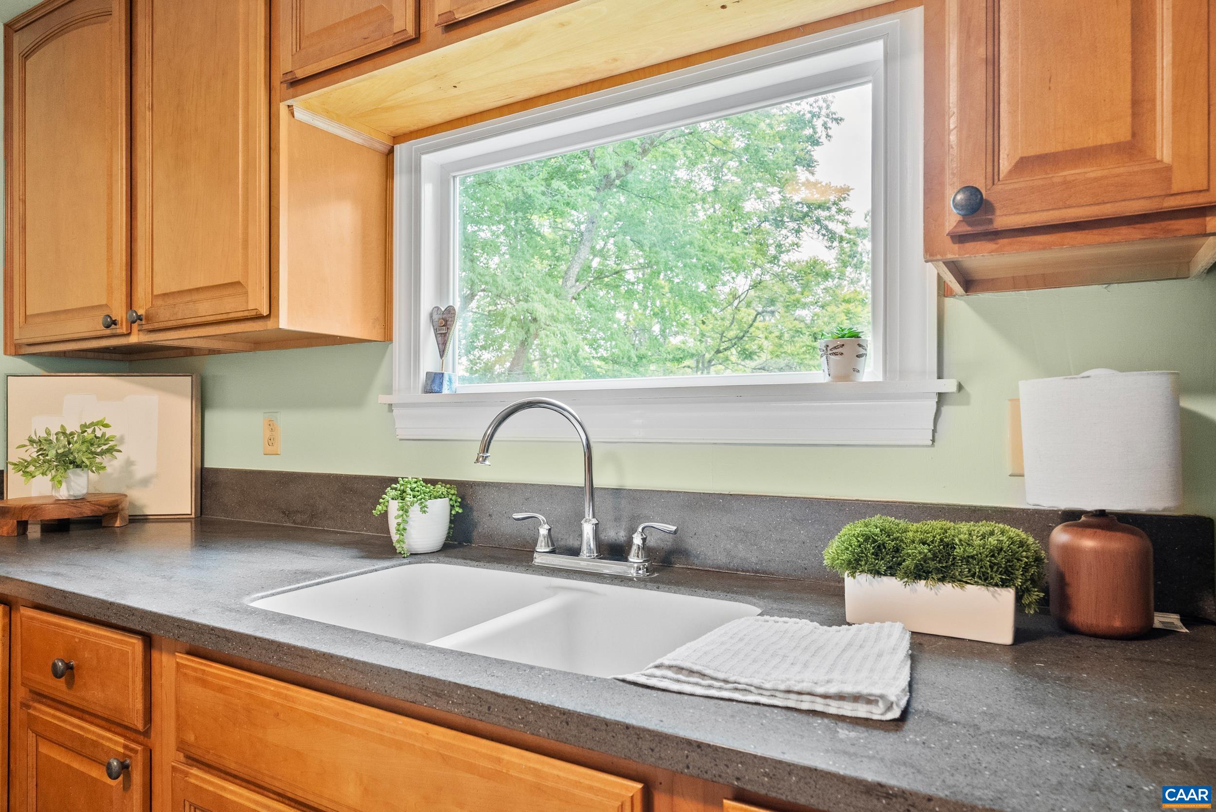 687 Gidsville Road Amherst, VA 24521 - Photo 25 of 70 a kitchen with granite countertop a sink and a white wooden cabinets