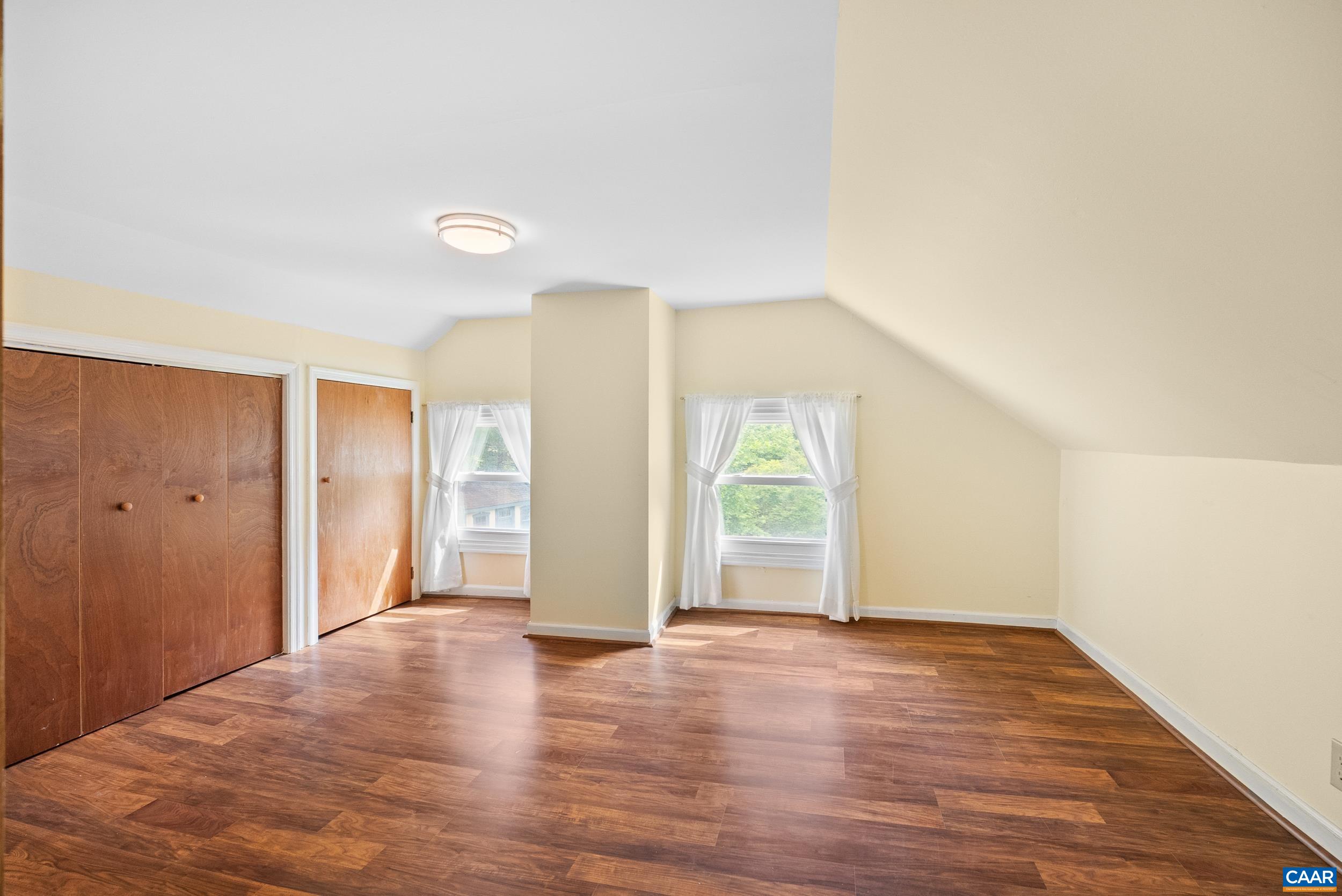 687 Gidsville Road Amherst, VA 24521 - Photo 31 of 70 an empty room with wooden floor and windows