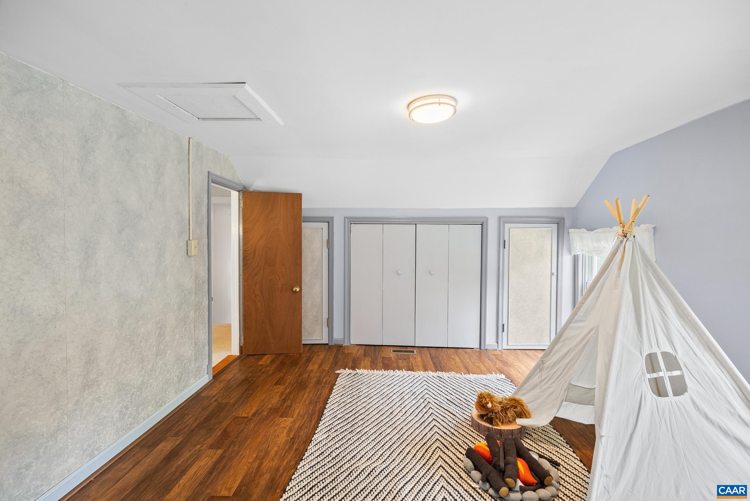 687 Gidsville Road Amherst, VA 24521 - Photo 34 of 70 a view of a bedroom with wooden floor and stairs