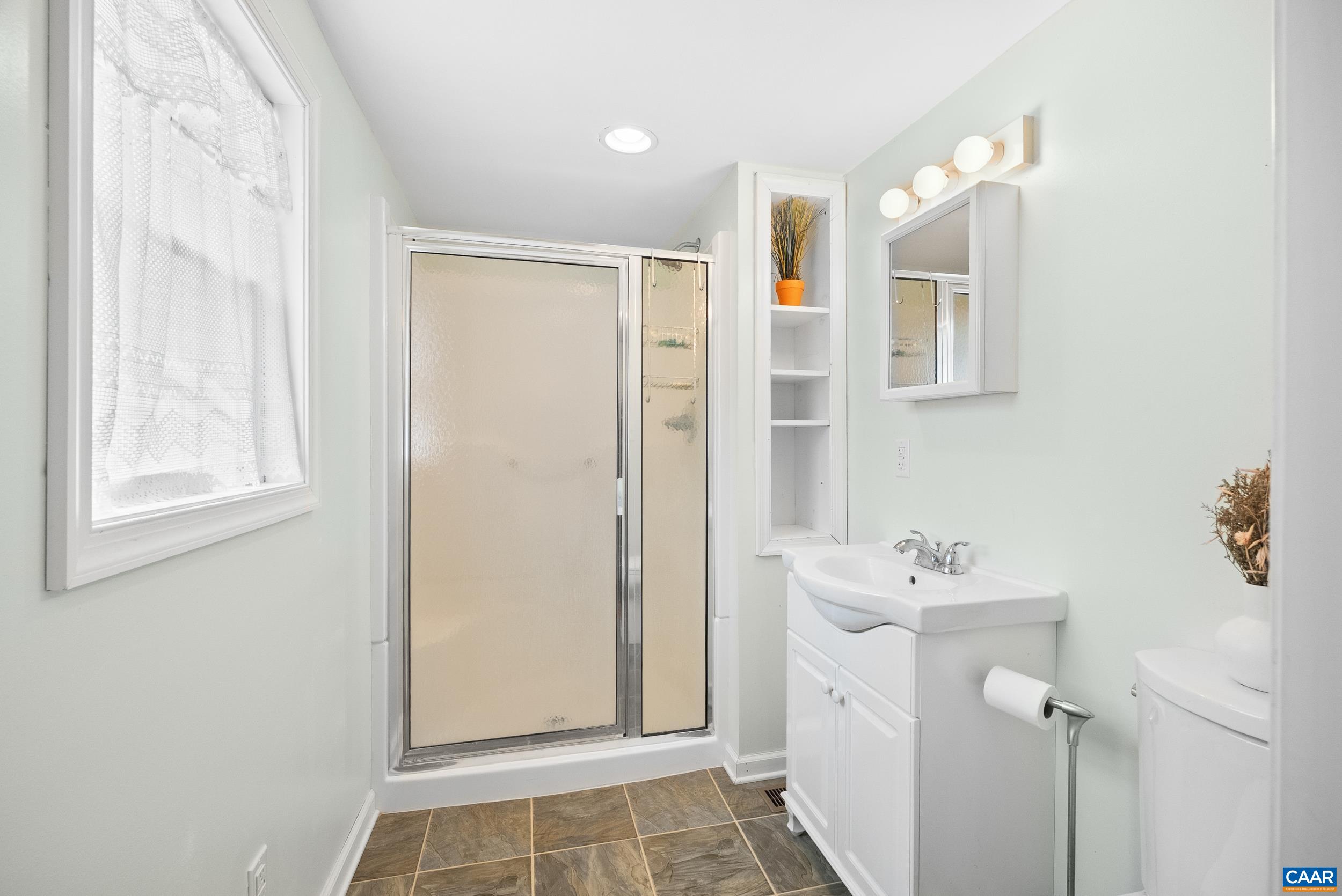 687 Gidsville Road Amherst, VA 24521 - Photo 36 of 70 a bathroom with a sink mirror and shower